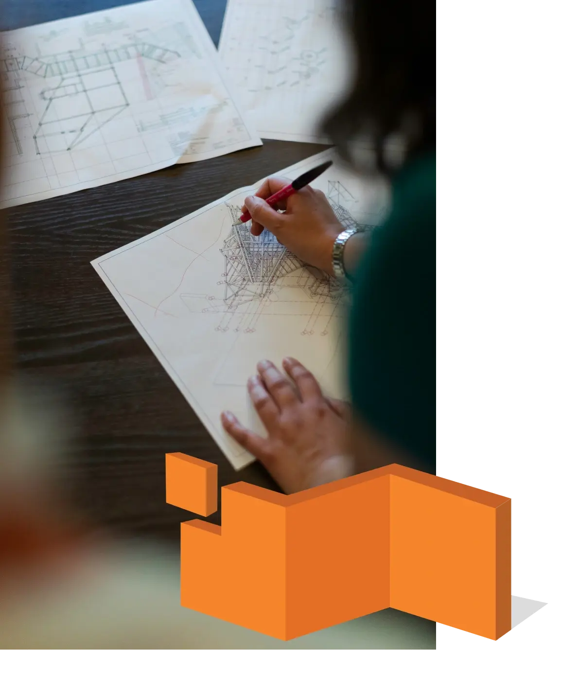 An engineer sketching structural details over drawings during preconstruction