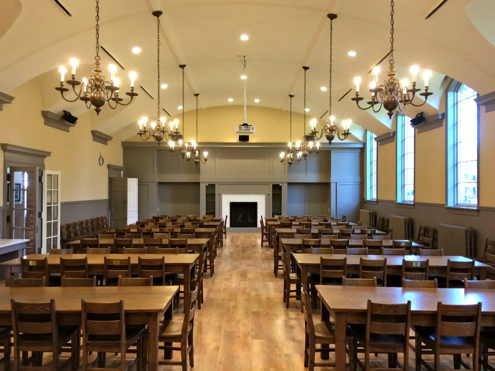 Restored heritage dining hall with vaulted ceiling and chandeliers